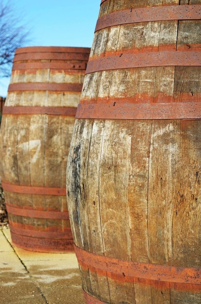 Two weathered oak barrels in the sun